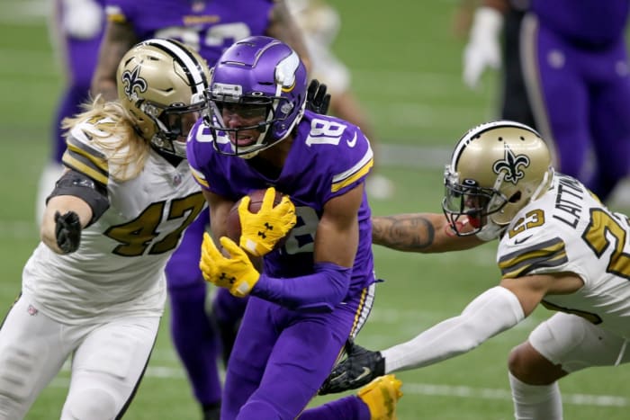 Minnesota Vikings receiver Justin Jefferson (18) runs between New Orleans Saints linebacker Alex Anzalone (47) and cornerback Marshon Lattimore (23) after a catch. Mandatory Credit: Chuck Cook-USA TODAY